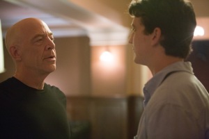 Andrew (Miles Teller) looking and listening to his mentor, the conductor Terence Fletcher (JK Simmons) as Fetcher gives him some advice.